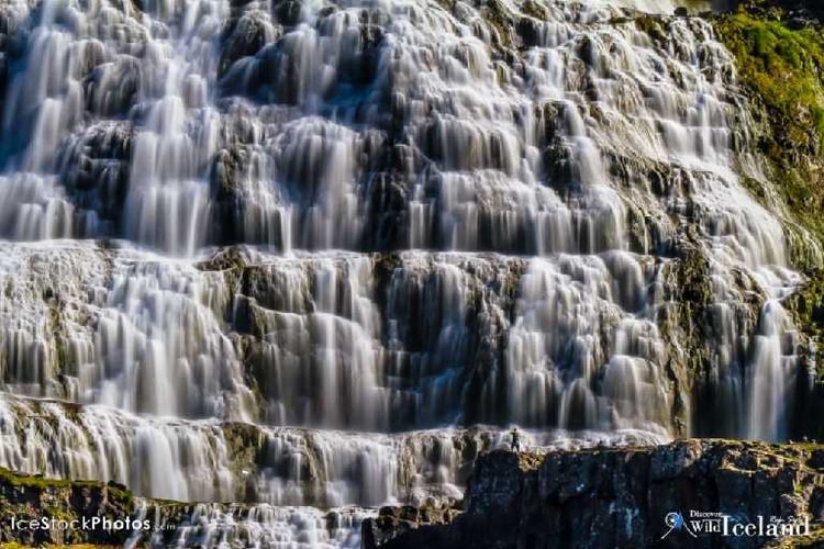 Dynjandi Waterfall, Westfjords, Iceland. Dynjandi (also known as Fjallfoss) is a series of waterfalls located in the Westfjords (Vestfirðir), Iceland. The waterfalls have a cumulative height of 100 metres (330 ft)